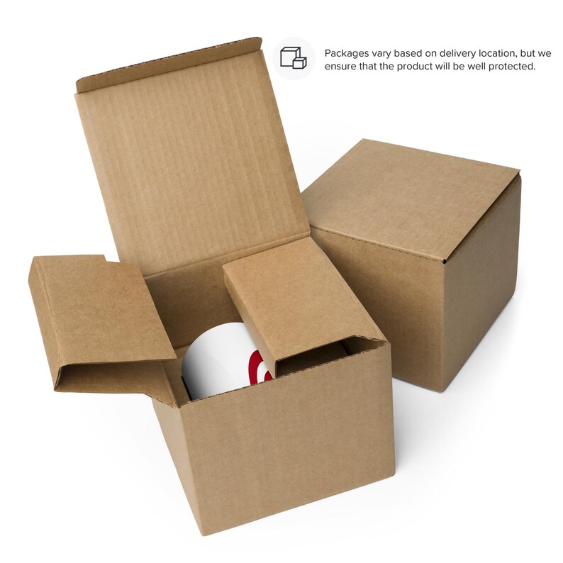 May include: A white mug with a red design is nestled inside a brown cardboard box with protective inserts. The box is open, revealing the mug, and is placed next to a closed box. Text on the image states, "Packages vary based on delivery location, but we ensure that the product will be well protected."