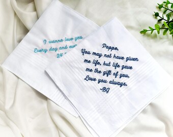 May include: Two white handkerchiefs with blue embroidery. One handkerchief says "I wanna love you Every day and ever 24" and the other says "Poppe. You may not have given me life, but life gave me the gift of you. Love you always. -B9"