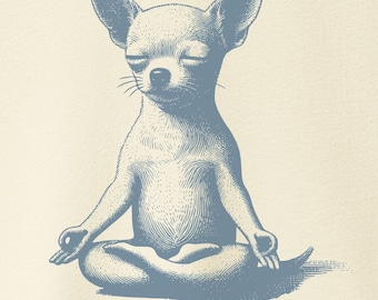 May include: Cream-colored t-shirt featuring a blue illustration of a meditating Chihuahua dog. The dog is in a lotus position with its eyes closed. The shirt has short sleeves and is hanging on a wooden hanger.