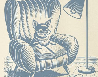 May include: Cream-colored t-shirt featuring a blue illustration of a chihuahua wearing glasses, reading a book in a cozy armchair. A floor lamp and slippers complete the scene. The shirt has a crew neck and short sleeves. The brand logo "TACO DOG" is on the upper right.