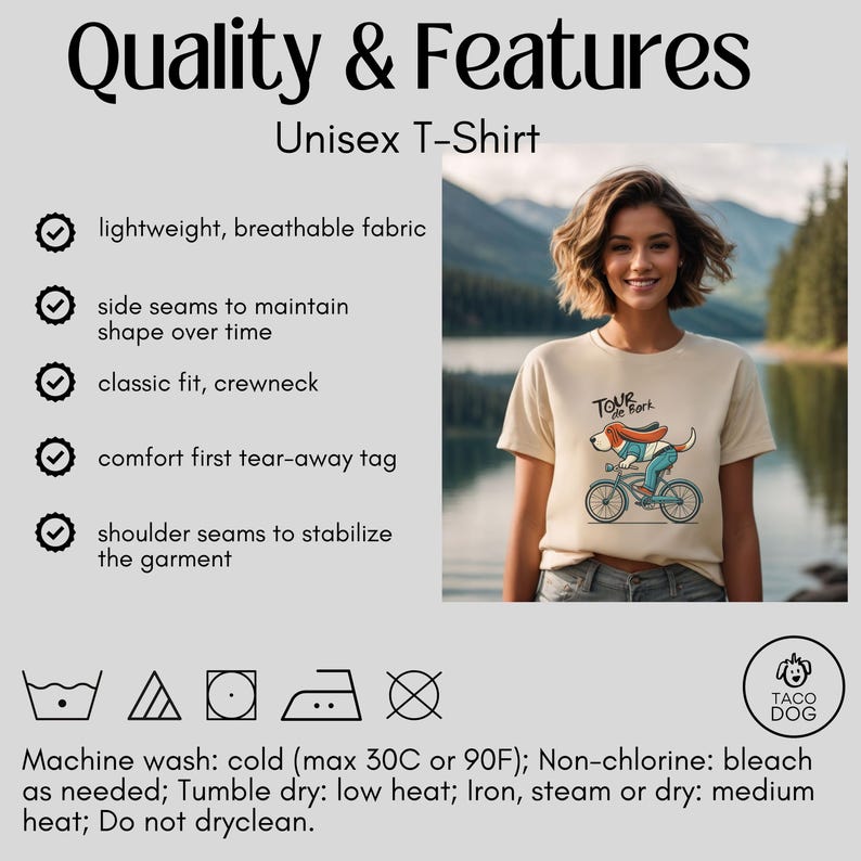 May include: Beige unisex t-shirt with a crew neck and short sleeves. The shirt features a cartoon dog riding a bicycle with the text "Tour de Bark". The shirt has a lightweight, breathable fabric and a classic fit. The shirt also has side and shoulder seams.
