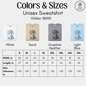 May include: A product image displays a unisex sweatshirt in four colors: white, sand, graphite heather, and light blue. Each sweatshirt features a dog graphic. A size chart shows width and length measurements in inches, ranging from S to 5XL.
