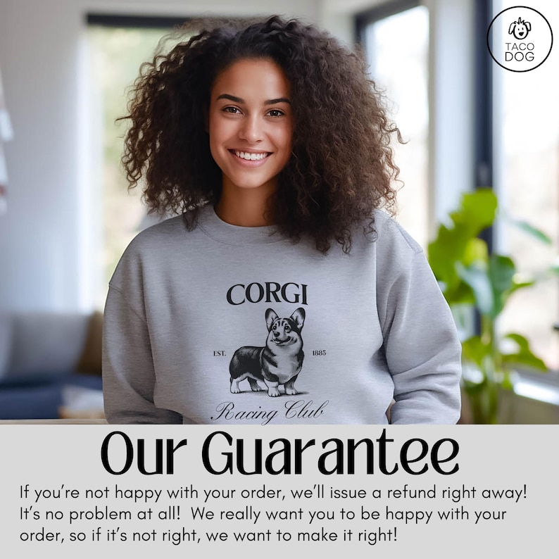 May include: A woman wearing a gray sweatshirt with a black and white illustration of a corgi dog. The sweatshirt has the text "CORGI Racing Club" and "EST. 1885".