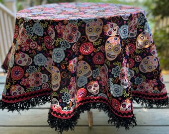 Colorful Day of the Dead Tablecloth Sugar Skulls Black and Pink Trim 49” round with glittering fringe