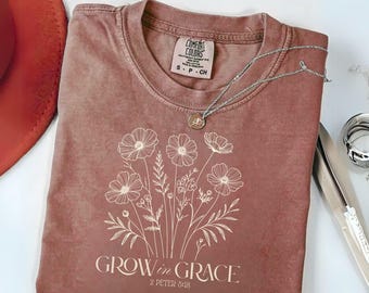 May include: A brown t-shirt with a white floral design and the text "GROW in GRACE 2 PETER 3:18".
