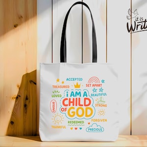 May include: White tote bag with black handles. The bag features a colourful design with the words "I am a child of God" and other positive affirmations. The words are in a rainbow of colours and surrounded by stars, hearts, and other fun designs.