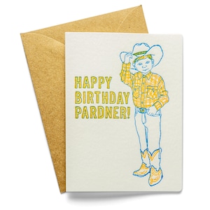 May include: A birthday card featuring a cartoon cowboy wearing a yellow and blue checked shirt, blue jeans and a yellow cowboy hat. The text on the card reads "Happy Birthday Pardner!"