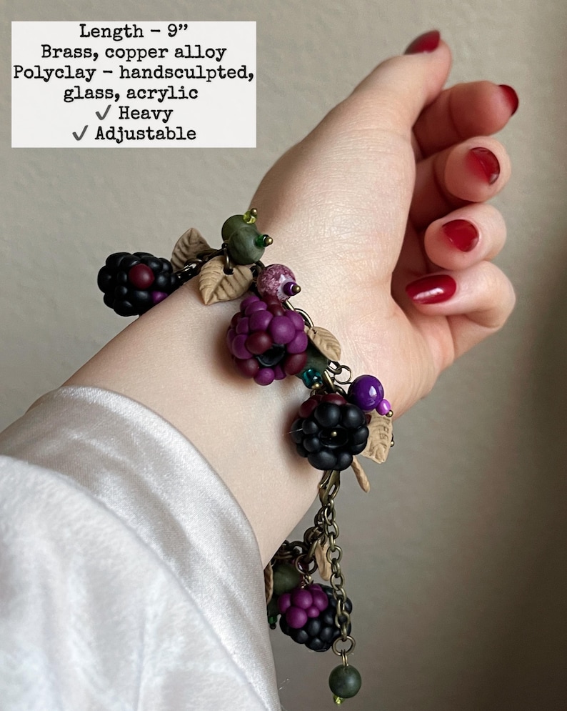 May include: A hand-sculpted bracelet with brass and copper alloy chains, polyclay blackberries, and glass beads. The bracelet is 22.86 cm long and has a heavy feel. The design includes adjustable features.