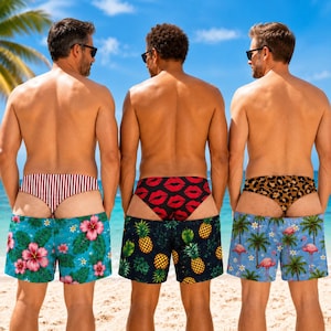 May include: Three pairs of swimming trunks featuring distinct patterns: the first has a red and white striped waistband with a teal floral print, the second a red lip print waistband with a pineapple print, and the third a leopard print waistband with flamingos.