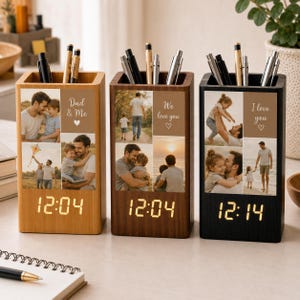 May include: Three rectangular wooden pen holders with integrated digital clocks displaying 12:04 or 12:14. Each holder features custom photo collages and text including Dad & Me, We love you, and I love you with heart icons, filled with various pens.
