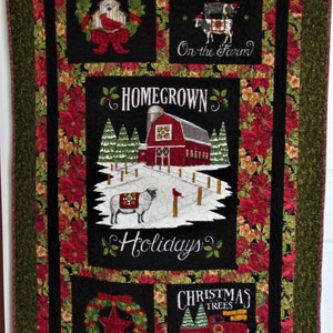May include: A black and red quilted wall hanging with a Christmas theme. It features a red barn, a wreath, a truck with Christmas trees, and the text "Homegrown Holidays", "Christmas on the Farm", and "Christmas Trees Farm Fresh".