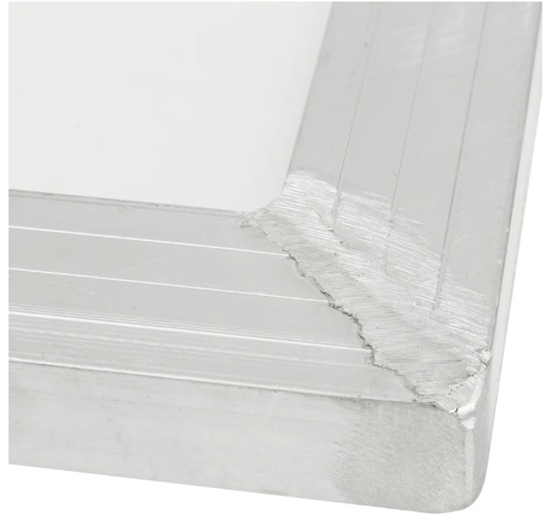 May include: Close-up of the corner of a silver aluminum frame. The frame has a textured surface and shows signs of wear and tear.