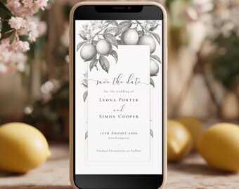 May include: A smartphone displays a grayscale wedding invitation with lemon and floral illustrations. The text "save the date" is at the top, followed by names, date, and location. Lemons and flowers are in the background.