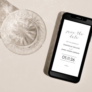 Contemporary paperless wedding save the date e-card shown on a smartphone next to a crystal tumbler