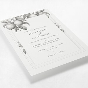 La Scorza botanical lemon wedding invitation shown at an angle