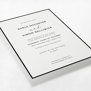 Perspective view of the Modern Border minimalist wedding invitation in black and white