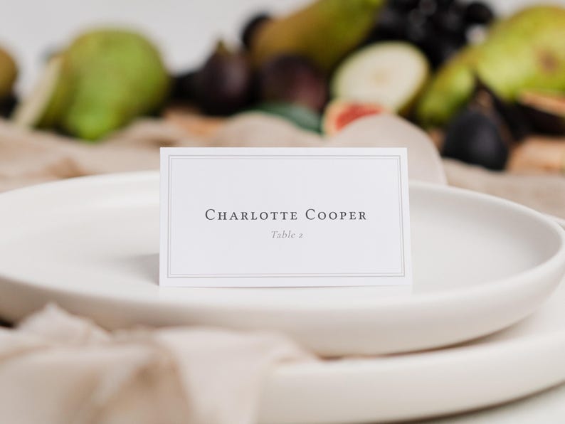 Elegant bordered folded wedding place card editable template with guest name and table number.