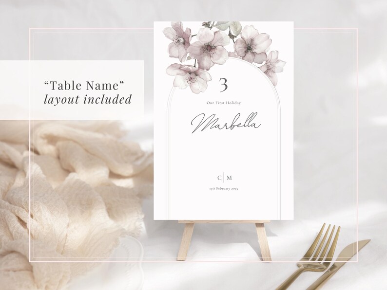 Sakura blossom blush pink wedding table name sign displayed on a stand