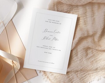May include: A white wedding invitation with elegant script, featuring the names Damara Carter and Robert Potter. The text "Save the Date" and wedding details are displayed within a thin border. The invitation rests on a beige fabric with a ribbon and envelope.