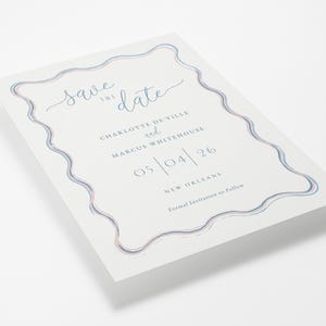The Wiggle collection pastel wavy border wedding save the date shown at an angle