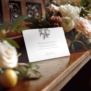 Elegant lemon wedding thank you card, pre-printed with a message, styled on a church pew with roses to the side and a lemon in the foreground.