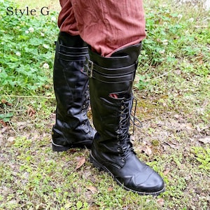 May include: Black leather knee-high boots with laces and buckles. The boots have a rounded toe and are worn with reddish-brown trousers. The text "Style G" is in the upper left corner.