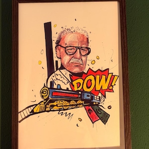 May include: Framed artwork featuring a cartoon illustration of a man with glasses and a mustache. A blue and yellow train with the word "EXCELSIOR" is depicted, along with the word "DOW!" in a speech bubble and money.