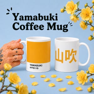 May include: Two white coffee mugs with the text "Yamabuki Coffee Mug". One mug has a solid orange color with the text "Yamabuki #FFB11B". The other mug has Japanese characters in orange.