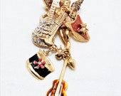 Vintage Kirk 39 s Folly Brooch with Angel and Musical Instruments Including 2 Guitars, a Trombone, a Harp, and Drum. It 39 s 2 3 4 In. Long. (B5)