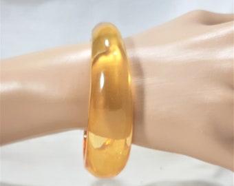 Vintage Transparent Golden Lucite Bangle. The Interior is 2 1/2 Inches in Diameter and 8 Inches in Circumference. It Looks Like Honey. (D32)