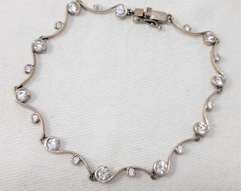 Vintage Sterling Silver Tennis Bracelet with Cubic Zirconia Stones, Push In Clasp. Measures 7 1/2 Inches Long. Marked H925 and DQCZ. (D16)