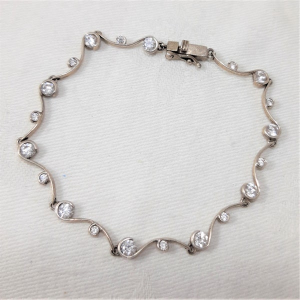 Vintage Sterling Silver Tennis Bracelet with Cubic Zirconia Stones, Push In Clasp. Measures 7 1/2 Inches Long. Marked H925 and DQCZ. (D16)