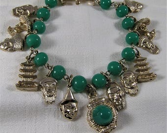 Vintage Asian Charm Bracelet with Peking Glass Beads and 10 Asian Face, 1 Lantern, 2 Temple Charms. Measures 7 3/4 Inches (D27)