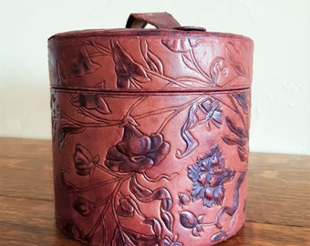 Vintage Collar Box with Tooled Floral Design. It Measures 6 Inches Tall and is 6 Inches in Diameter. Made of Burgundy Leather and Cardboard.