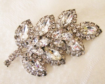 Vintage Rhinestone Brooch in a Leafy Design with Prong Set Clear Stones Made in Juliana Style. It Measures  3 Inches by 1 1/2 Inches. (D3)