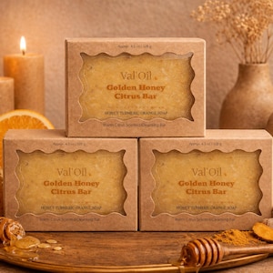 May include: Three rectangular bars of Val'Oil Golden Honey Citrus Bar soap, each in a brown cardboard box with a scalloped window. The labels state Honey Turmeric Orange Soap and Warm Citrus Scented Cleansing Bar, with a weight of 128 g.