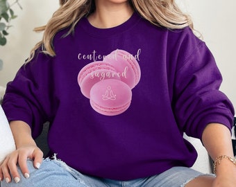 May include: Purple sweatshirt with a pink macaron graphic and the text "centered and sugared".