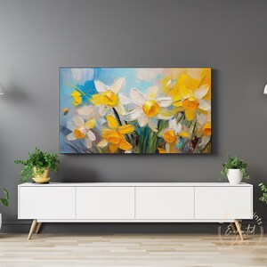 May include: A painting of a bouquet of white and yellow daffodils with green leaves against a blue and white background.