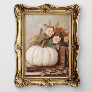 May include: A framed still life painting featuring a white pumpkin, roses, and books. The artwork is set in an ornate gold frame. The color palette includes cream, brown, and gold tones, evoking a sense of autumn and classic decor.