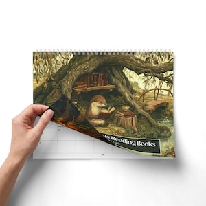 2027 wall calendar featuring cute woodland animals reading books, twelve
illustrated forest library scenes with fox, hedgehog, rabbit, squirrel, otter and
raccoon in hollow-tree bookshops and mushroom libraries, cozy cottagecore
storybook art, 12 month hanging calendar printed and shipped, book lover gift for
readers librarians and teachers, reading nook and home office decor