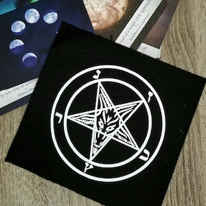 May include: Black patch with a white pentagram with a wolf's head in the center. The pentagram is surrounded by a circle with Hebrew letters.