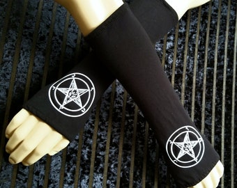 May include: A pair of black arm warmers with a white pentagram design. The arm warmers are made of a soft, stretchy fabric and are perfect for adding a touch of gothic style to any outfit.