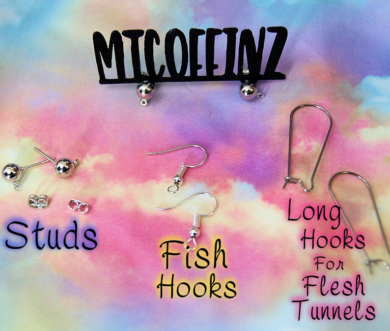 May include: A variety of earring findings, including studs, fish hooks, and long hooks for flesh tunnels. The findings are silver in color and are displayed on a pink and blue tie-dye background. The text "MICOFFINZ" is displayed at the top of the image.