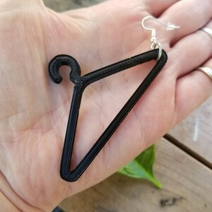 May include: Black 3D printed hanger earring with a silver hook.