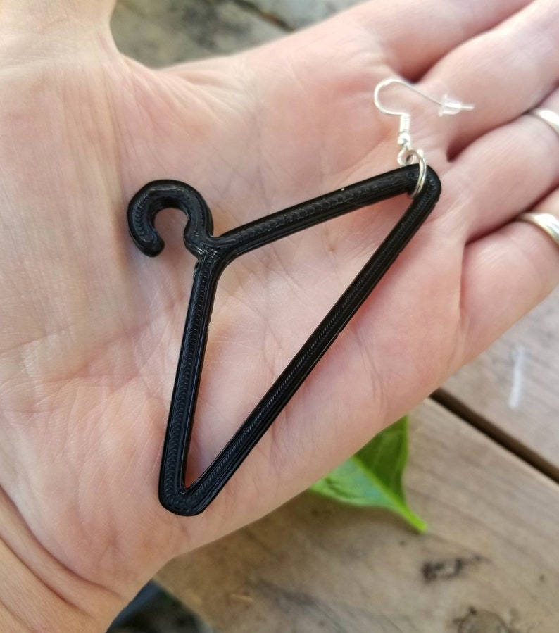 May include: Black 3D printed hanger earring with a silver hook.