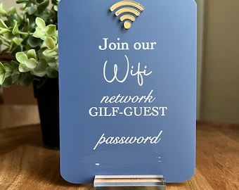 May include: A blue sign with a gold wifi symbol and the text "Join our Wifi network GILF-GUEST password".