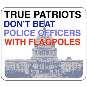 May include: A sign with the text "TRUE PATRIOTS DON'T BEAT POLICE OFFICERS WITH FLAGPOLES" in black, blue, and red text. The sign features a gray silhouette of the US Capitol building.