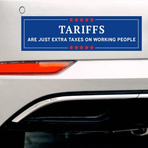 May include: A blue bumper sticker with white text that reads "TARIFFS ARE JUST EXTRA TAXES ON WORKING PEOPLE." The word "TARIFFS" is in large capital letters. The sticker has red stars at the top and bottom.