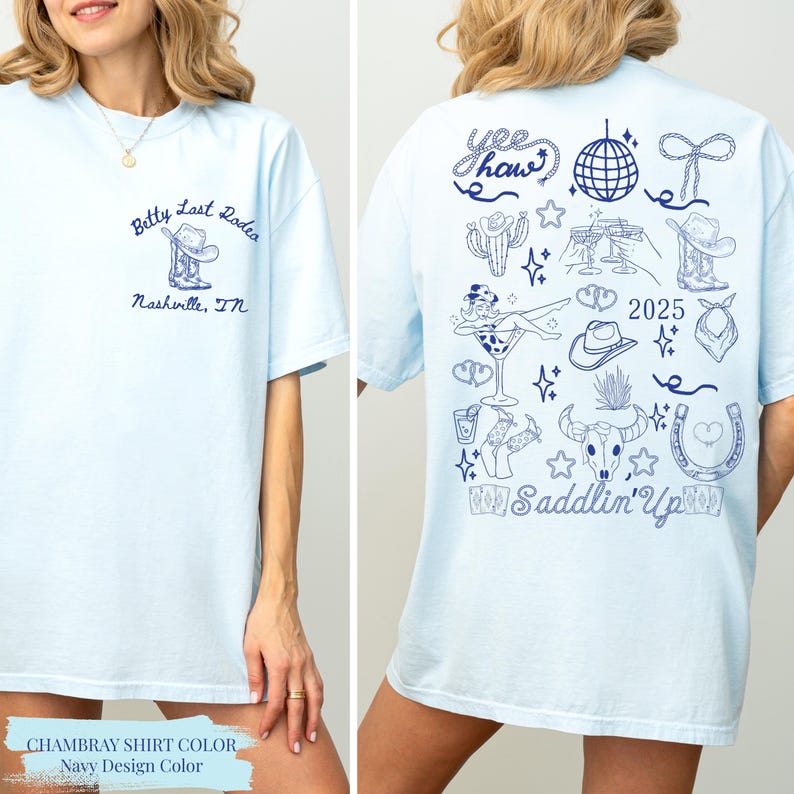 May include: Pale blue t-shirt with navy blue illustrations. Front displays "Betty Last Rodeo Nashville, TN" and a boot graphic. The back features "Yee Haw" text, a disco ball, cowboy-themed drawings, and "2025" and "Saddlin' Up" text.