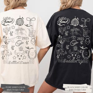 May include: Two t-shirts, one cream and one black, with a black and white design. The design includes a disco ball, cowboy hat, cactus, and the text "Yee Haw" and "Settlin' Down" or "Saddlin' Up".